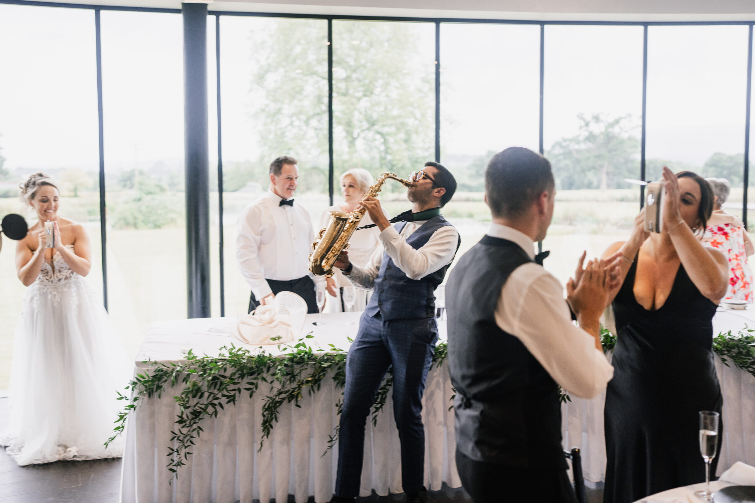 Alex Rimell playing the Saxophone at a wedding.